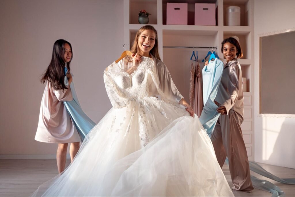 The bride is dressed by two wedding stylists